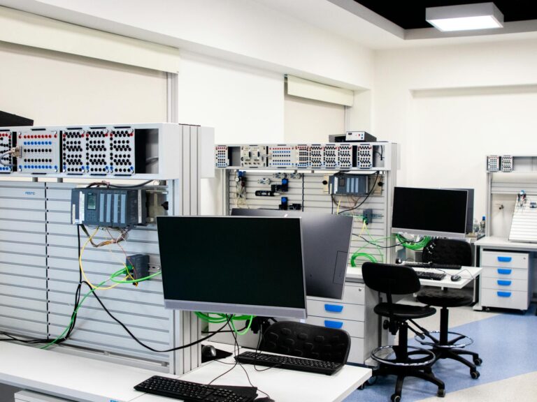 A contemporary computer lab with advanced workstations and electronic equipment, perfect for research and development.
